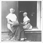 SA1424 - Two Shaker women sitting in a doorway. Image used for an article on Shaker furniture. Illustration for Junior Bazaar